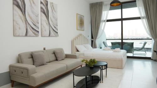 a living room with a couch and a bed at Dimorelux l Club Vista Mare l Five Palm Jumeirah in Dubai