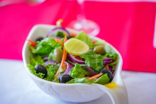 a salad in a white bowl on a table at The Ridge Residence in Victoria