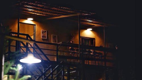a room with a staircase and a light at night at Maison de Hill Home in Dồng Văn