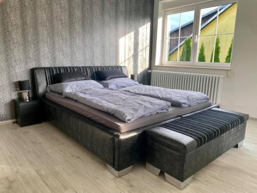 a large bed in a bedroom with a window at Apartman Maxim N9 in Kežmarok