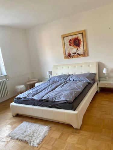 a white bed in a bedroom with a white wall at Apartman Maxim N9 in Kežmarok