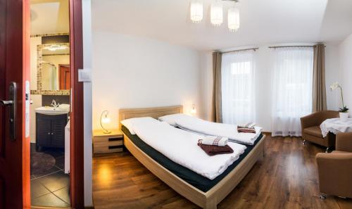a bedroom with a bed and a living room at Willa Dorotka in Kudowa-Zdrój
