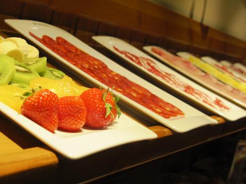a buffet of food with strawberries and sausages at Peira Blanca Hotel Gastronómico in Garós