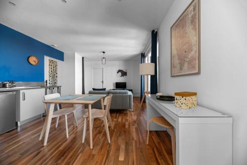 a kitchen and living room with a table and chairs at Résidence Léon Blum - Appartements design - Parking in Clermont-Ferrand