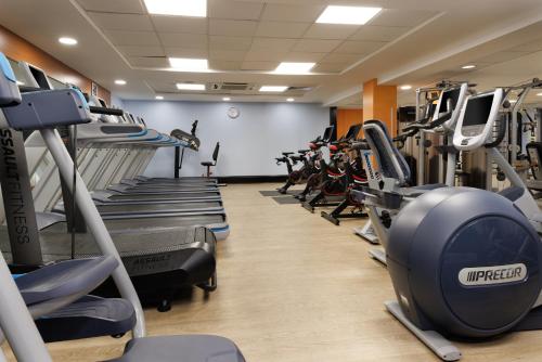 a gym with rows of treadmills and machines at Hilton Leicester Hotel in Leicester