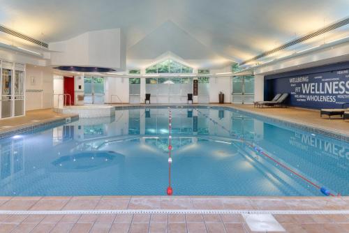 a large swimming pool in a building at Hilton Leicester Hotel in Leicester