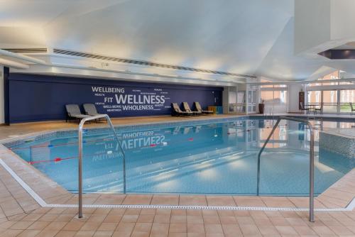 a large swimming pool in a building at Hilton Leicester Hotel in Leicester