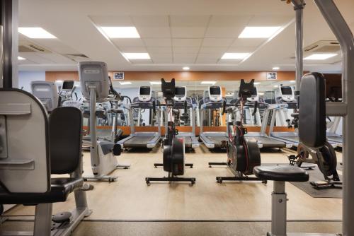 a gym with a lot of tread machines at Hilton Leicester Hotel in Leicester