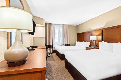 a hotel room with two beds and a lamp at Comfort Inn Modesto in Modesto