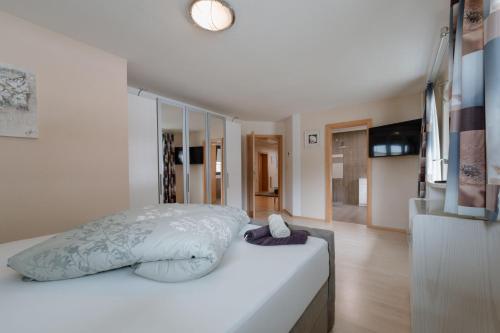 a bedroom with a bed with a white comforter at Haus Schennach in Längenfeld