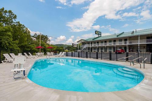 a swimming pool in front of a hotel at Quality Inn in Weston