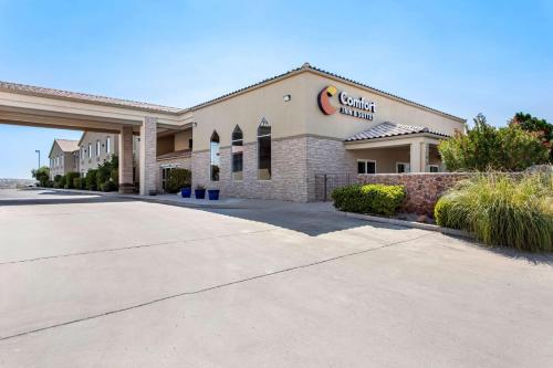 a front view of a building with a car dealership at Comfort Inn & Suites I-25 near Spaceport America in Truth or Consequences