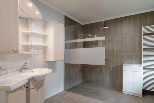 a bathroom with a sink and a shower at Haus Schennach in Längenfeld