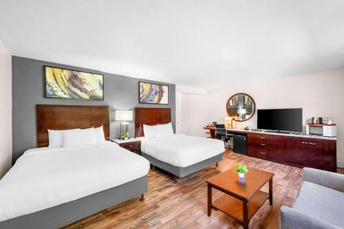 a hotel room with two beds and a tv at Quality Inn & Suites in Jackson