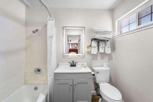 a bathroom with a sink and a toilet and a tub at Quality Inn & Suites in Jackson