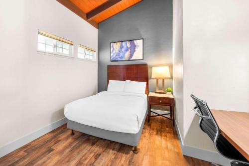 a small bedroom with a bed and a desk at Quality Inn & Suites in Jackson