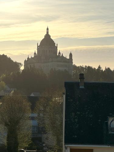 a large building sitting on top of a city at Cocoon’Lis, 2 pièces en plein centre ville in Lisieux