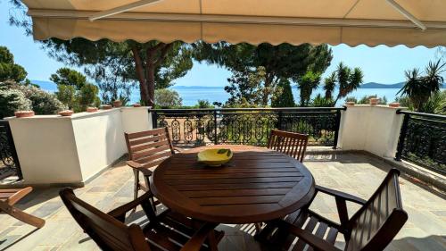 a wooden table and chairs on a patio at Ekatis Seacoast Nest in Livanátai