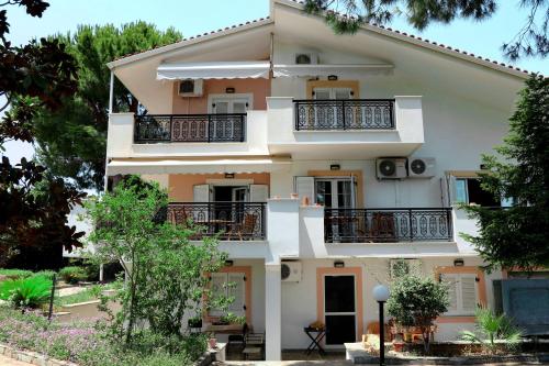 a large house with balconies and trees at Ekatis Seacoast Nest in Livanátai