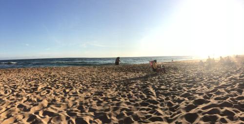 a group of people standing on a sandy beach at Las Coloniales in Sauce de Portezuelo
