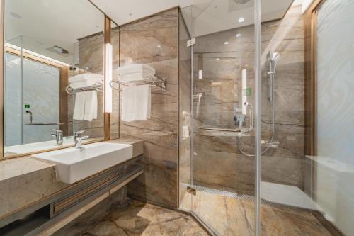 a bathroom with a sink and a shower at Holiday Inn Zhengzhou Zhongzhou by IHG in Zhengzhou