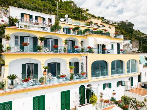 a building with green shutters and balconies at Hotel Il Nido in Amalfi