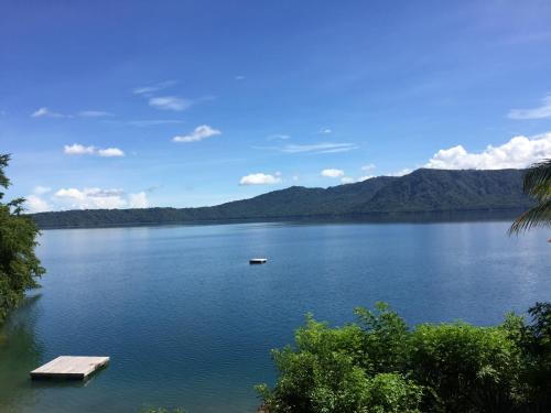 a view of a lake with a dock and mountains at Laguna Beach Club in La Laguna
