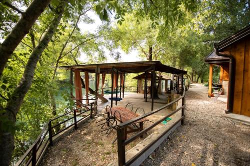 a park with a bench and a pavilion at Riverside Cabin in Čapljina