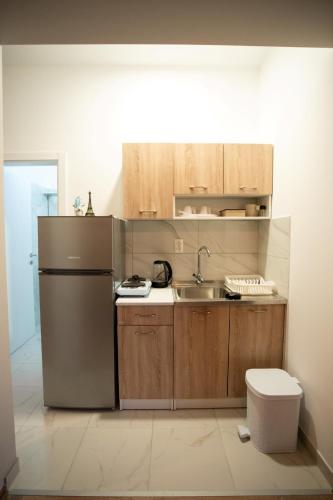 a kitchen with a refrigerator and a sink at Riverside Cabin in Čapljina