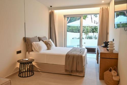 a bedroom with a bed and a large window at Rhotheon Suites in Ialysos Rhodes - private pool in selected rooms in Ialysos