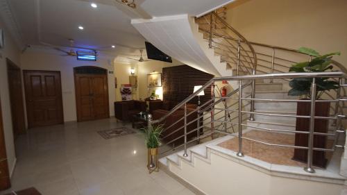 a staircase in a house with a living room at World Inn by WI Hotel in Karachi