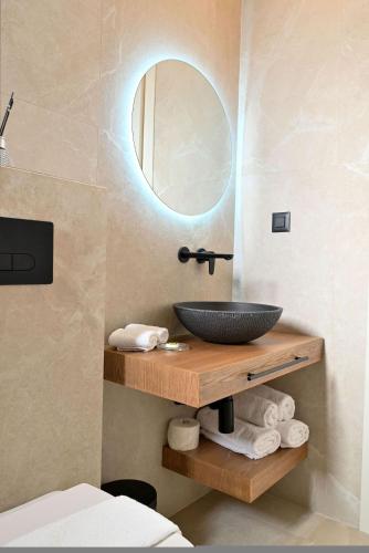 a bathroom with a sink and a mirror at Rhotheon Suites in Ialysos Rhodes - private pool in selected rooms in Ialysos