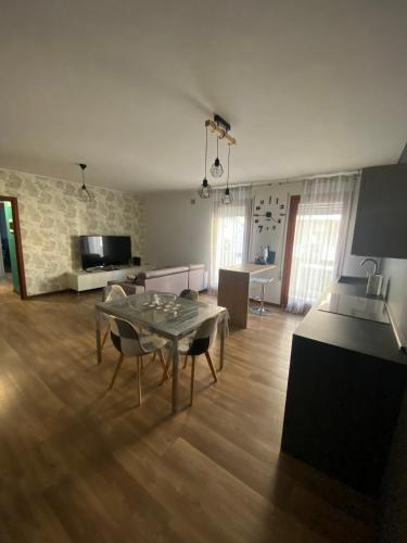 a living room with a dining table and a kitchen at M&C House in Ponterotto