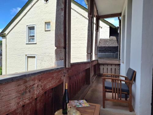 a bottle of wine sitting on a porch with a window at Nikola in Merl