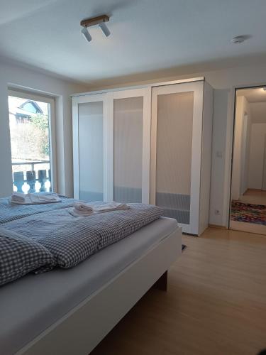 a bedroom with a bed and a large window at Haus Obermaiselstein in Obermaiselstein