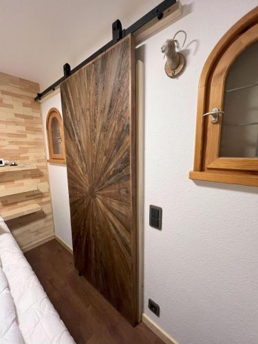 a sliding door in a room with a bed at Haus Obermaiselstein in Obermaiselstein