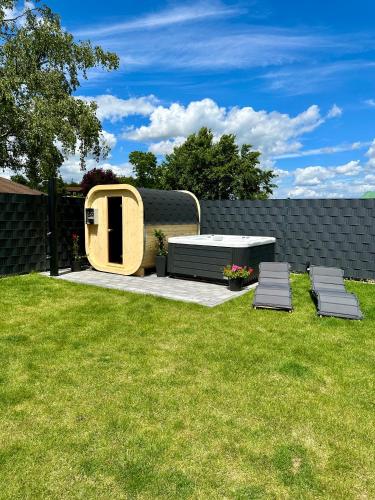 a backyard with a picnic table and two chairs at Chalet Lasserg in Münstermaifeld