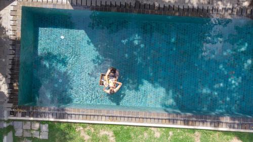 an overhead view of a person in a swimming pool at Villa Hillcrest in Weligama