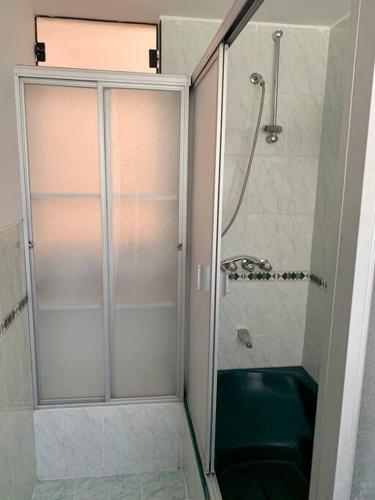 a shower with a glass door in a bathroom at Yanahuara La Casa del Angel in Yanahuara