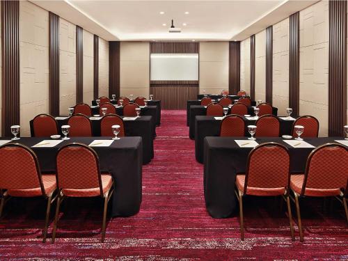 a conference room with tables and chairs in it at Mercure Karawang in Karawang