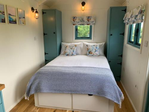 a bedroom with a bed in a small room at St. Kew Shepherd Huts in Wadebridge