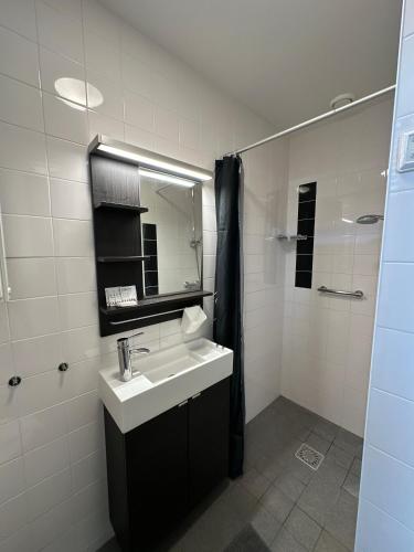 a bathroom with a sink and a mirror at De Schelp 86, Garden and Free parking in Zandvoort