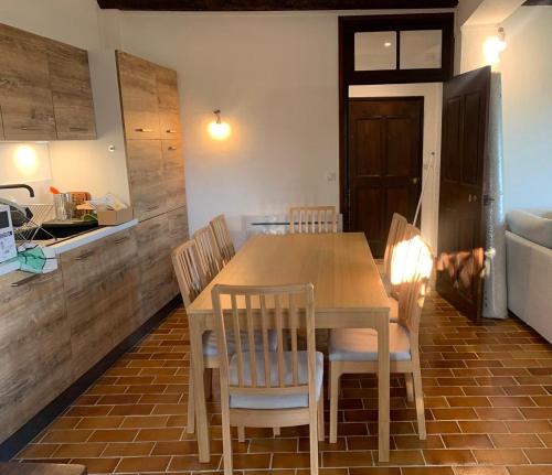 a kitchen with a wooden table and chairs in a room at Sublime maison de montagne in Guillaumes