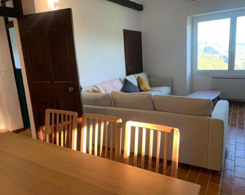 a living room with a couch and a table at Sublime maison de montagne in Guillaumes