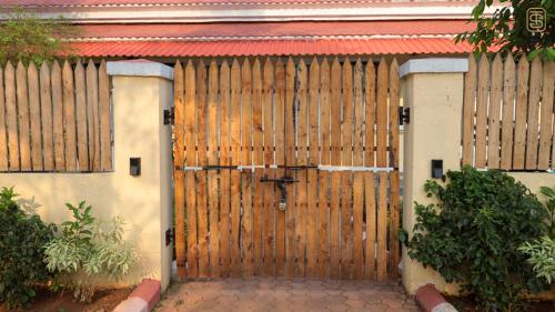 a large wooden door of a house with at Thai Stays Villa in Shenwa
