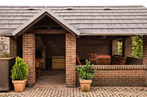 a brick pavilion with a roof on a patio at Penzión Pri Mlyne in Nitra