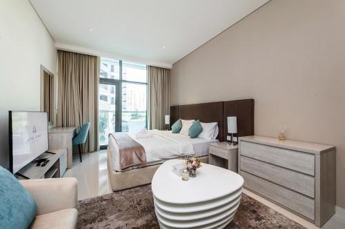 a bedroom with a bed and a living room at Popular Seven Palm Apartments in Dubai