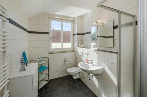 コルスヴァントにあるHaus Inesの洗面台とトイレを備えた白いバスルーム