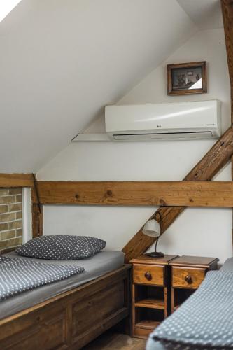 a bedroom with two bunk beds in a attic at Penzión Pri Mlyne in Nitra