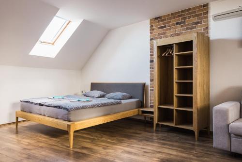 a bedroom with a bed and a brick wall at Penzión Pri Mlyne in Nitra
